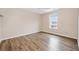 Bedroom features wood floors, neutral walls, white trim, a window, and lots of space at 28 Eagle Glen Ne Dr, Cartersville, GA 30121