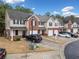 View of townhomes with brick and siding, driveway parking, well-maintained landscaping, and garage at 28 Eagle Glen Ne Dr, Cartersville, GA 30121