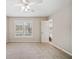 Bedroom featuring neutral carpet, a ceiling fan, a window with shutters, and an attached bathroom at 407 Paper Mill Lndg, Roswell, GA 30076