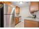 Bright kitchen with stainless steel refrigerator, light cabinets, and granite countertops at 407 Paper Mill Lndg, Roswell, GA 30076