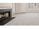 Spacious living room with a fireplace, neutral carpet, and ample natural light at 407 Paper Mill Lndg, Roswell, GA 30076