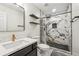 Modern bathroom featuring a walk-in shower with marble tiling, wall shelves, and black fixtures at 56 Ruth Way, Douglasville, GA 30134