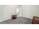 Bedroom featuring neutral carpet, white walls, a side table, and two doors at 56 Ruth Way, Douglasville, GA 30134