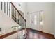 Elegant foyer featuring hardwood floors, staircase with iron railing, and a stylish console table at 56 Ruth Way, Douglasville, GA 30134