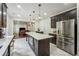 Open concept kitchen features black cabinetry, stainless steel appliances, and a view into the living room at 56 Ruth Way, Douglasville, GA 30134