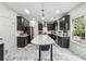 Modern kitchen featuring black cabinets, stainless steel appliances, a large island with a white countertop at 56 Ruth Way, Douglasville, GA 30134