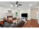 Inviting living room with a brown leather sofa, fireplace, and wood floors, creating a comfortable space at 56 Ruth Way, Douglasville, GA 30134