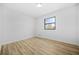 Bright bedroom with light wood floors, neutral walls, and a large window with a view at 897 Marie Lane Sw Ln, Conyers, GA 30094