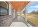 A close up of the covered front porch with wood ceiling shows the brick facade of the home at 897 Marie Lane Sw Ln, Conyers, GA 30094