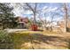 Wide backyard view showcasing a lush lawn, a backyard studio, and mature trees at 944 Cherokee Se Ave, Atlanta, GA 30315