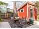 The backyard shows a red backyard studio with chairs and a grill, surrounded by a stone ground at 944 Cherokee Se Ave, Atlanta, GA 30315