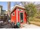 The backyard shows a red backyard studio with chairs and a grill, surrounded by a stone ground at 944 Cherokee Se Ave, Atlanta, GA 30315