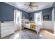 Cozy bedroom with blue walls, white trim and hardwood floors at 944 Cherokee Se Ave, Atlanta, GA 30315