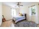 Cozy bedroom features a bed, stylish rug, two windows with white curtains, and a ceiling fan at 944 Cherokee Se Ave, Atlanta, GA 30315