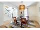 Spacious dining room adjacent to the staircase with hardwood floors, chandelier, and natural light at 944 Cherokee Se Ave, Atlanta, GA 30315