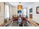 Traditional dining room with hardwood floors, a colorful rug, and a unique chandelier at 944 Cherokee Se Ave, Atlanta, GA 30315