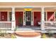 Charming front porch with red siding, number, and a swing at 944 Cherokee Se Ave, Atlanta, GA 30315