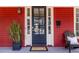 Charming front door with welcome mat, potted plant, and Adirondack chair at 944 Cherokee Se Ave, Atlanta, GA 30315