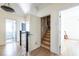 Bright hallway featuring wood floors, multiple doorways, and a staircase to the attic at 944 Cherokee Se Ave, Atlanta, GA 30315