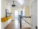 Bright hallway featuring a yellow floating console table and hardwood floors at 944 Cherokee Se Ave, Atlanta, GA 30315