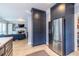 Kitchen with stainless refrigerator, dark cabinets, and view into living room at 944 Cherokee Se Ave, Atlanta, GA 30315