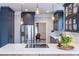 Kitchen featuring stainless steel appliances, marble countertops, a center island, and hardwood floors at 944 Cherokee Se Ave, Atlanta, GA 30315