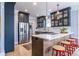 Kitchen island with seating, stainless appliances, blue cabinets and hardwood floors at 944 Cherokee Se Ave, Atlanta, GA 30315