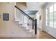 Bright foyer featuring a staircase with white risers and black handrail leading to the second floor at 944 Cherokee Se Ave, Atlanta, GA 30315