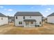 View of the home's backyard and rear exterior, featuring a covered patio at 1038 Blue Juniper Cir, Loganville, GA 30052