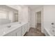 Bathroom with a dual-sink vanity, large mirror, and tiled floors at 1038 Blue Juniper Cir, Loganville, GA 30052