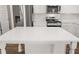 Close up of kitchen island with quartz countertop and stainless steel appliances in background at 1038 Blue Juniper Cir, Loganville, GA 30052