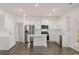 Modern kitchen with stainless appliances, center island, white cabinets, and plenty of counter space at 1038 Blue Juniper Cir, Loganville, GA 30052