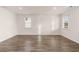 Spacious living room with hardwood flooring and an abundance of natural light from two windows at 1038 Blue Juniper Cir, Loganville, GA 30052