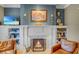 Inviting living room with built-in shelves, a cozy fireplace, and comfortable leather seating at 15 Northwood Ne Ave, Atlanta, GA 30309