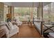 Cozy porch featuring a swing bed, chairs, and brick flooring at 15 Northwood Ne Ave, Atlanta, GA 30309