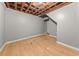 Unfinished basement with wooden floors and exposed ceiling beams at 1707 Terry Mill Road Se Rd, Atlanta, GA 30316