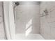 Elegant bathroom shower with marble tile surround and modern fixtures at 1707 Terry Mill Road Se Rd, Atlanta, GA 30316