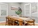 Bright dining room with large windows and a modern table with seating for eight at 1707 Terry Mill Se Rd, Atlanta, GA 30316