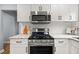 Bright kitchen with stainless steel appliances, granite countertops, and white cabinets at 1707 Terry Mill Se Rd, Atlanta, GA 30316