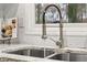 Close up of a kitchen sink with granite countertop and faucet with running water at 1707 Terry Mill Se Rd, Atlanta, GA 30316