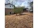 Leafy backyard featuring a gentle slope, fenced boundary, and carport at 2724 Hickory Smoke Ct, Snellville, GA 30078