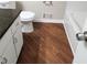 Bathroom with white cabinets, a granite countertop, and wood-look flooring at 2724 Hickory Smoke Ct, Snellville, GA 30078