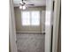 View into a bedroom featuring neutral walls, carpet flooring, ceiling fan, and natural light at 2724 Hickory Smoke Ct, Snellville, GA 30078