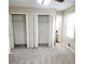 Bedroom boasts gray carpet, two closets, and natural light from a window at 2724 Hickory Smoke Ct, Snellville, GA 30078