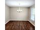 Cozy dining room with hardwood floors, neutral paint, and a classic chandelier at 2724 Hickory Smoke Ct, Snellville, GA 30078