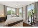 Bright bedroom featuring large windows, modern ceiling fan and stylish decor at 508 Boardwalk Way, Alpharetta, GA 30022