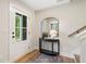 Entryway with a glass-panel front door, stylish console table, and staircase at 508 Boardwalk Way, Alpharetta, GA 30022