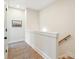 Bright hallway showcasing hardwood floors, neutral paint, modern railing, and natural light from nearby stairs at 508 Boardwalk Way, Alpharetta, GA 30022