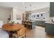 Open concept kitchen with sage cabinetry, stainless steel appliances, and kitchen island with pendant lighting at 508 Boardwalk Way, Alpharetta, GA 30022