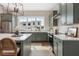 Well-lit kitchen with sage cabinets, stainless steel appliances, and a large kitchen island at 508 Boardwalk Way, Alpharetta, GA 30022